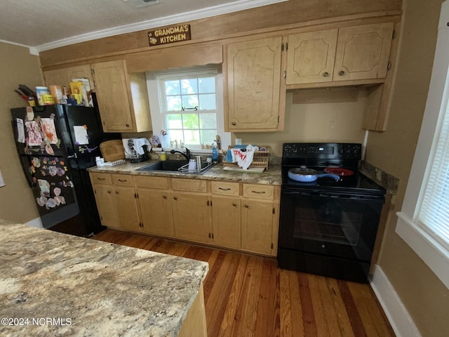 kitchen featuring light brown cabinetry, sink, light hardwood / wood-style floors, black appliances, and crown molding