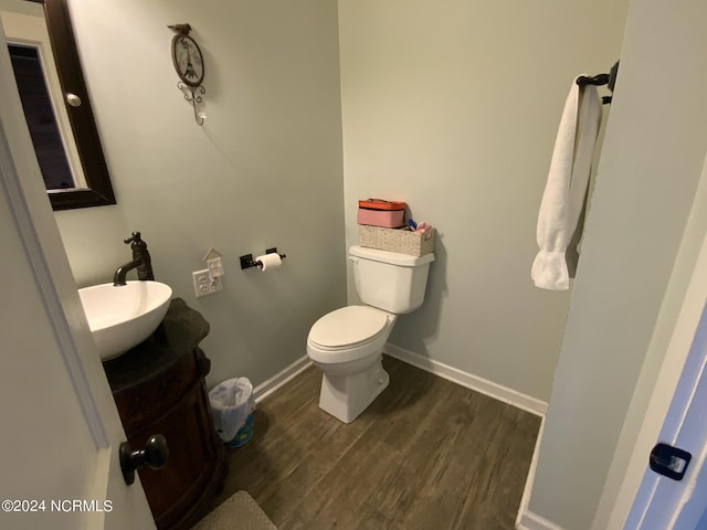 bathroom with vanity, hardwood / wood-style flooring, and toilet