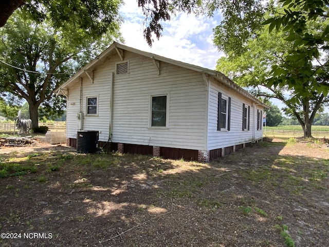 view of side of property with cooling unit