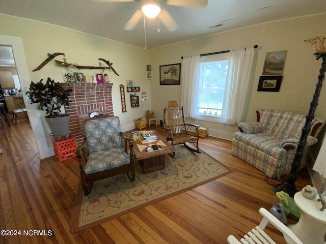 living room featuring wood-type flooring and ceiling fan