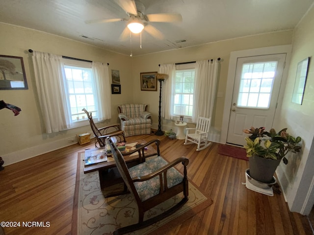 sitting room featuring a wealth of natural light, wood-type flooring, and ceiling fan