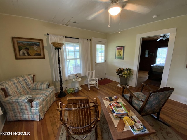 living room featuring hardwood / wood-style floors and ceiling fan