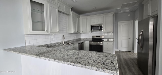 244 Grandview Dr, Sneads Ferry, NC 28460 - kitchen with light stone countertops, glass insert cabinets, appliances with stainless steel finishes, and a sink
