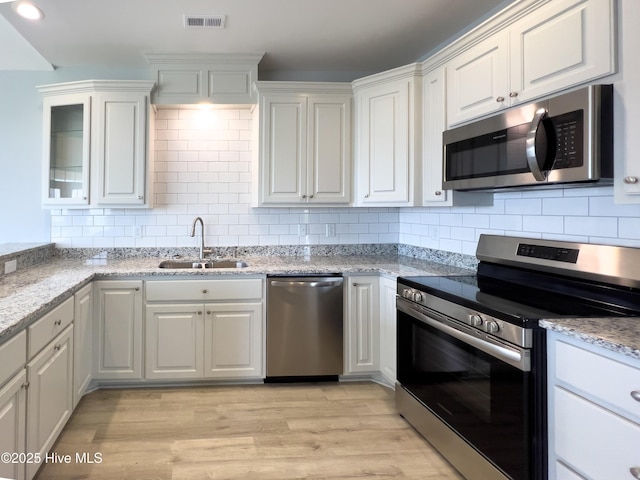 244 Grandview Dr, Sneads Ferry, NC 28460 - kitchen with white cabinets, stainless steel appliances, visible vents, and a sink