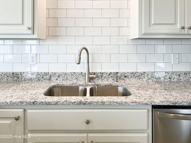 244 Grandview Dr, Sneads Ferry, NC 28460 - details featuring light stone countertops, decorative backsplash, stainless steel dishwasher, and a sink