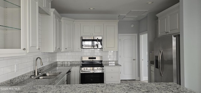 244 Grandview Dr, Sneads Ferry, NC 28460 - kitchen with a sink, light stone counters, stainless steel appliances, and tasteful backsplash
