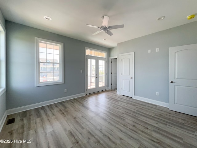 244 Grandview Dr, Sneads Ferry, NC 28460 - unfurnished bedroom with wood finished floors, french doors, baseboards, and multiple windows