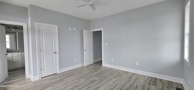 244 Grandview Dr, Sneads Ferry, NC 28460 - unfurnished bedroom with baseboards, light wood-type flooring, multiple windows, and ensuite bathroom
