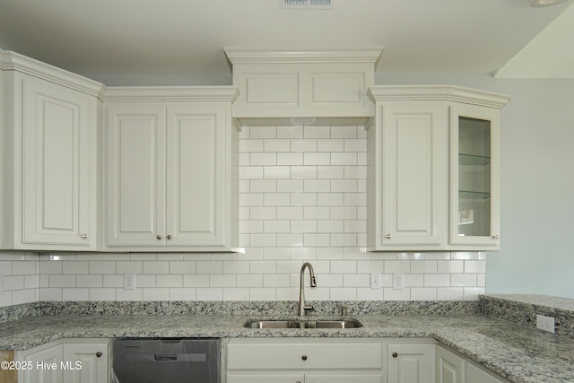 kitchen with dishwasher, sink, and white cabinets