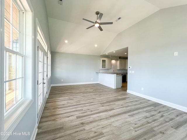 244 Grandview Dr, Sneads Ferry, NC 28460 - unfurnished living room featuring light wood finished floors, vaulted ceiling, french doors, baseboards, and ceiling fan