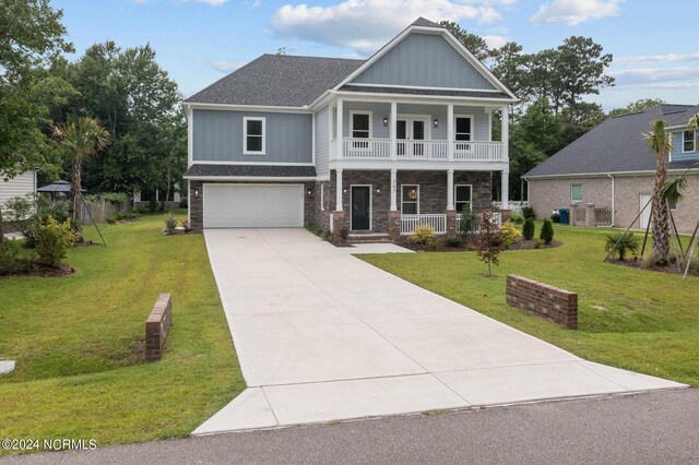 craftsman-style home with a garage, a balcony, a porch, and a front yard