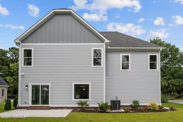 back of property featuring cooling unit, a yard, and a patio