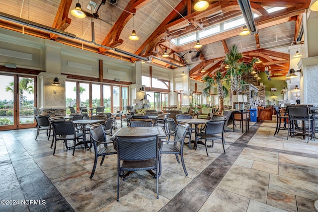 dining space featuring beam ceiling, high vaulted ceiling, and wooden ceiling