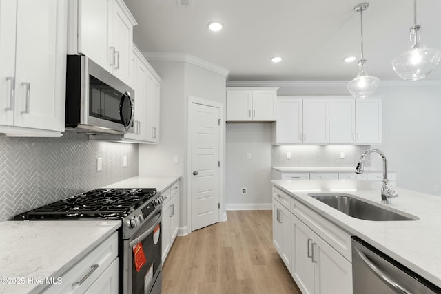 kitchen featuring stainless steel appliances, sink, and white cabinets