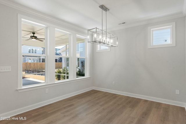 unfurnished dining area featuring hardwood / wood-style flooring and ornamental molding