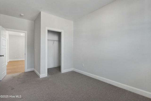 unfurnished bedroom featuring carpet floors and a closet