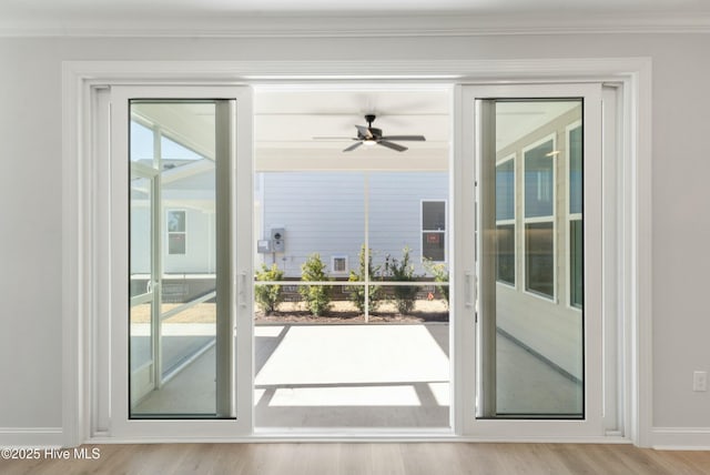 entryway with crown molding, light hardwood / wood-style flooring, and ceiling fan