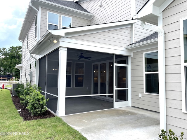 entrance to property featuring ceiling fan and a patio