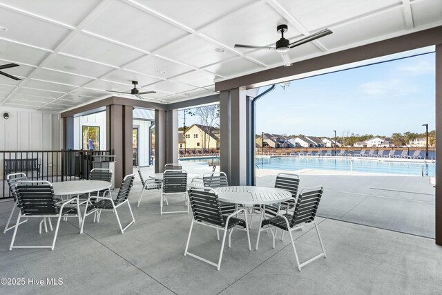 view of patio featuring a community pool and ceiling fan