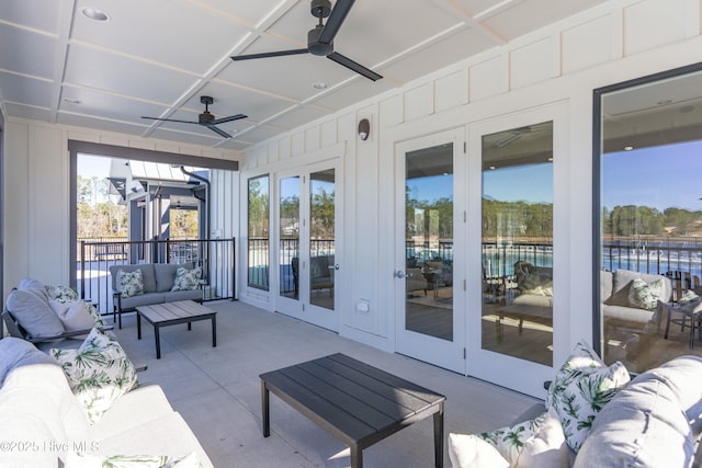 sunroom / solarium featuring ceiling fan