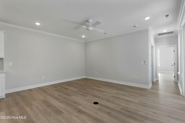 empty room featuring crown molding, light hardwood / wood-style flooring, and ceiling fan