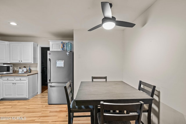 dining room featuring ceiling fan and light wood-type flooring