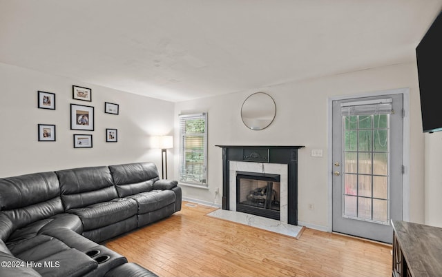 living room featuring a high end fireplace and hardwood / wood-style floors