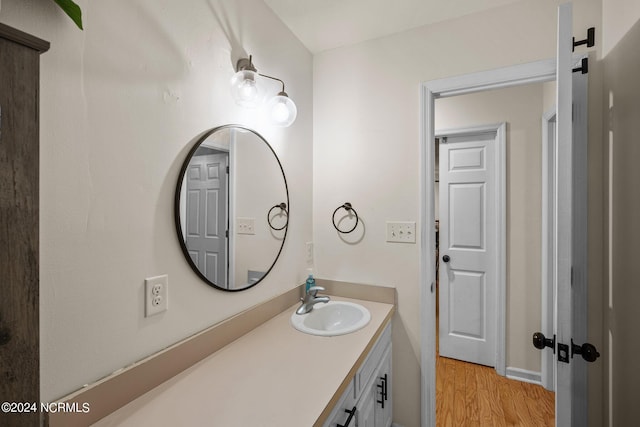 bathroom featuring vanity and hardwood / wood-style floors