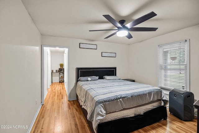 bedroom with ceiling fan and light hardwood / wood-style flooring