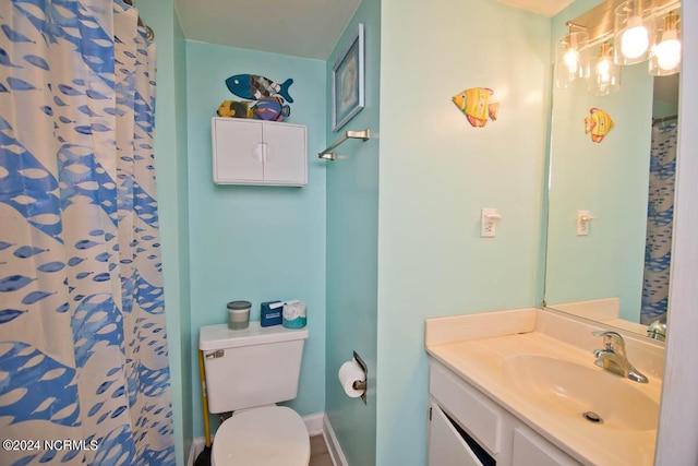 bathroom with curtained shower, vanity, and toilet