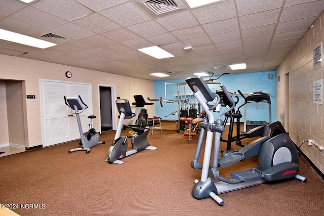 workout area with visible vents and concrete block wall