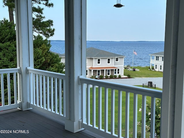 exterior space featuring a lawn and a water view