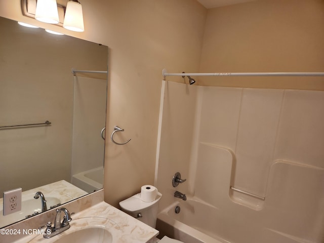 full bathroom featuring washtub / shower combination, vanity, and toilet