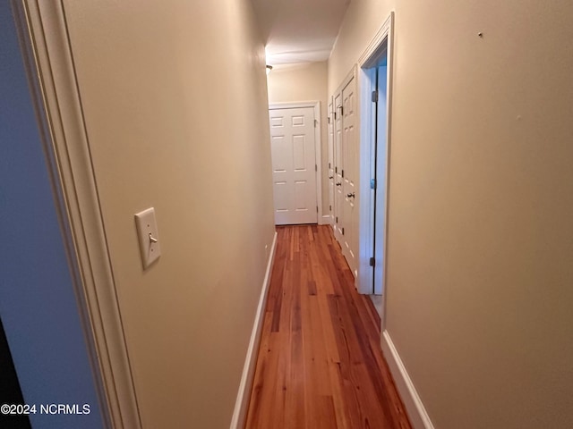 corridor with light hardwood / wood-style flooring