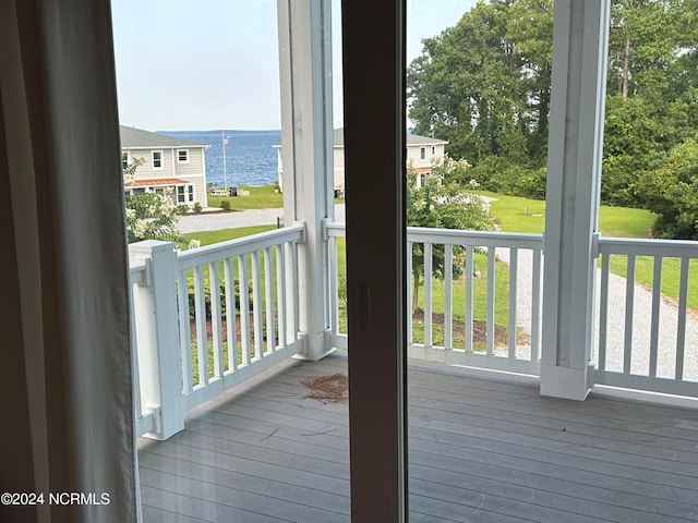 entryway with a healthy amount of sunlight, a water view, and hardwood / wood-style floors