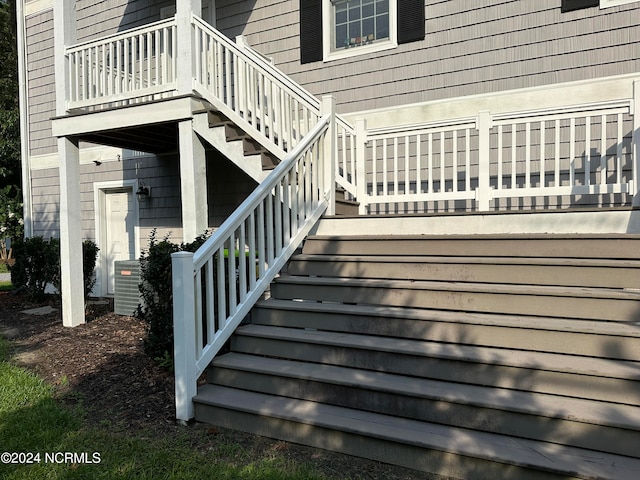 wooden terrace featuring stairway and central air condition unit