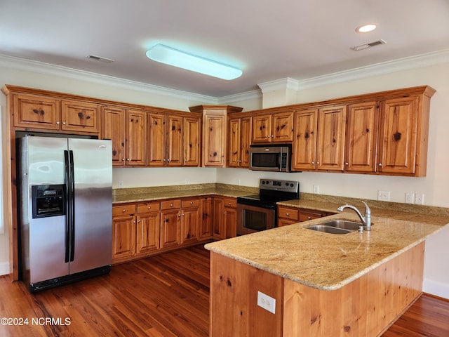 kitchen with dark hardwood / wood-style flooring, stainless steel appliances, sink, and kitchen peninsula