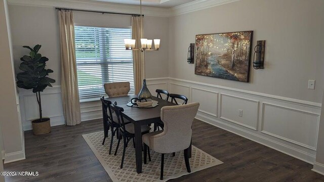 dining room featuring ornamental molding, dark wood-type flooring, and ceiling fan with notable chandelier