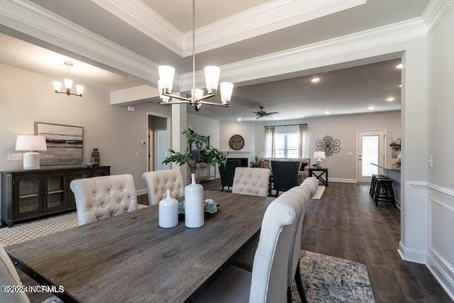 carpeted bedroom with crown molding, ceiling fan, and a tray ceiling