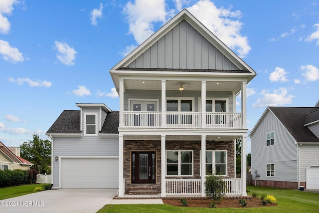 view of front of property with a garage, a balcony, covered porch, and a front lawn