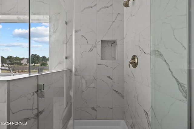 bathroom featuring a shower with door