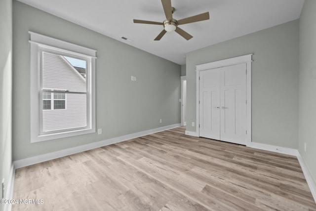 unfurnished bedroom featuring a closet, ceiling fan, and light hardwood / wood-style flooring