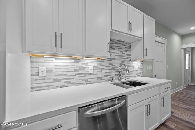 kitchen with sink, white cabinetry, dark hardwood / wood-style flooring, dishwasher, and decorative backsplash