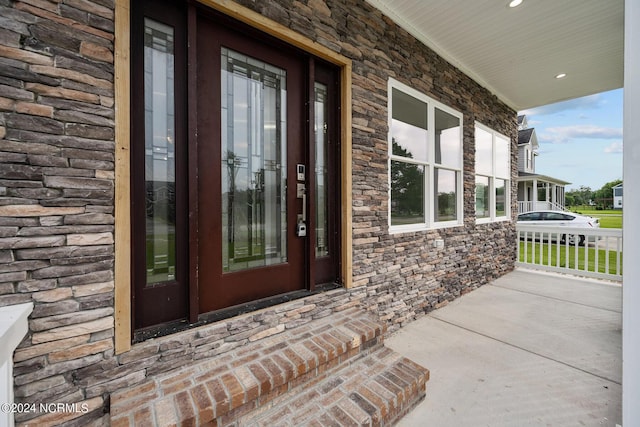 view of exterior entry featuring a porch