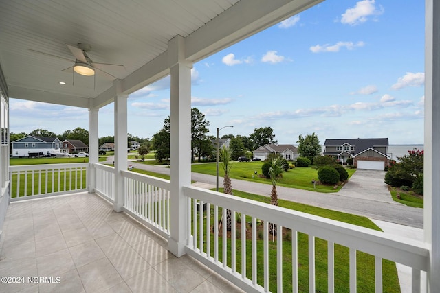 balcony with ceiling fan and a porch