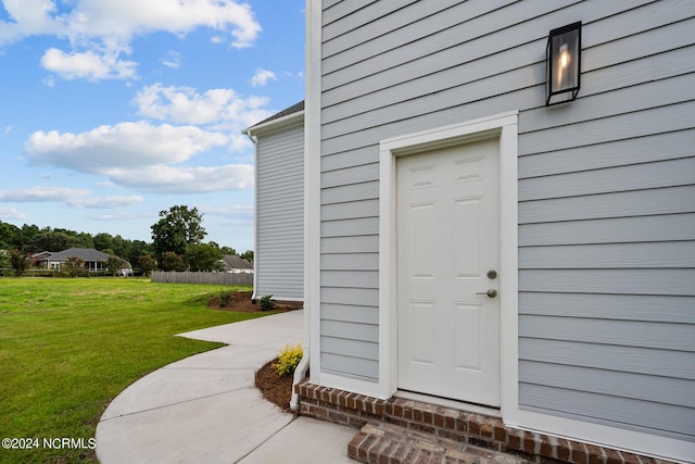 doorway to property featuring a yard