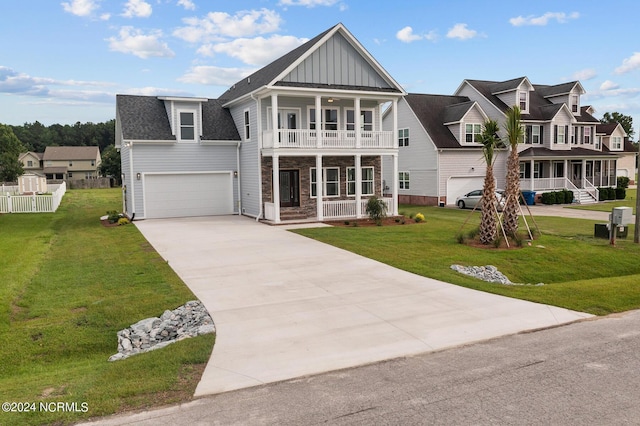 view of front of property with a garage, a front lawn, a balcony, and covered porch