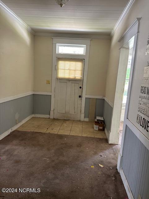 entrance foyer with crown molding and a wealth of natural light