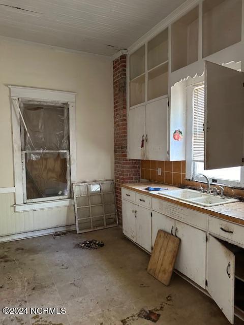 kitchen with white cabinetry and sink