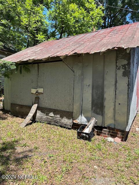 view of outbuilding with a yard